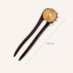 Wooden hair comb with decorative top on a white background