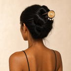 Woman with styled hair featuring a decorative hairpin against a beige background