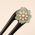 Close-up of green glaze flower ebony wood hair fork with smooth hand-polished finish and floral accent for thick hair updos