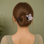 Model wearing purple flower HairFork in a low bun