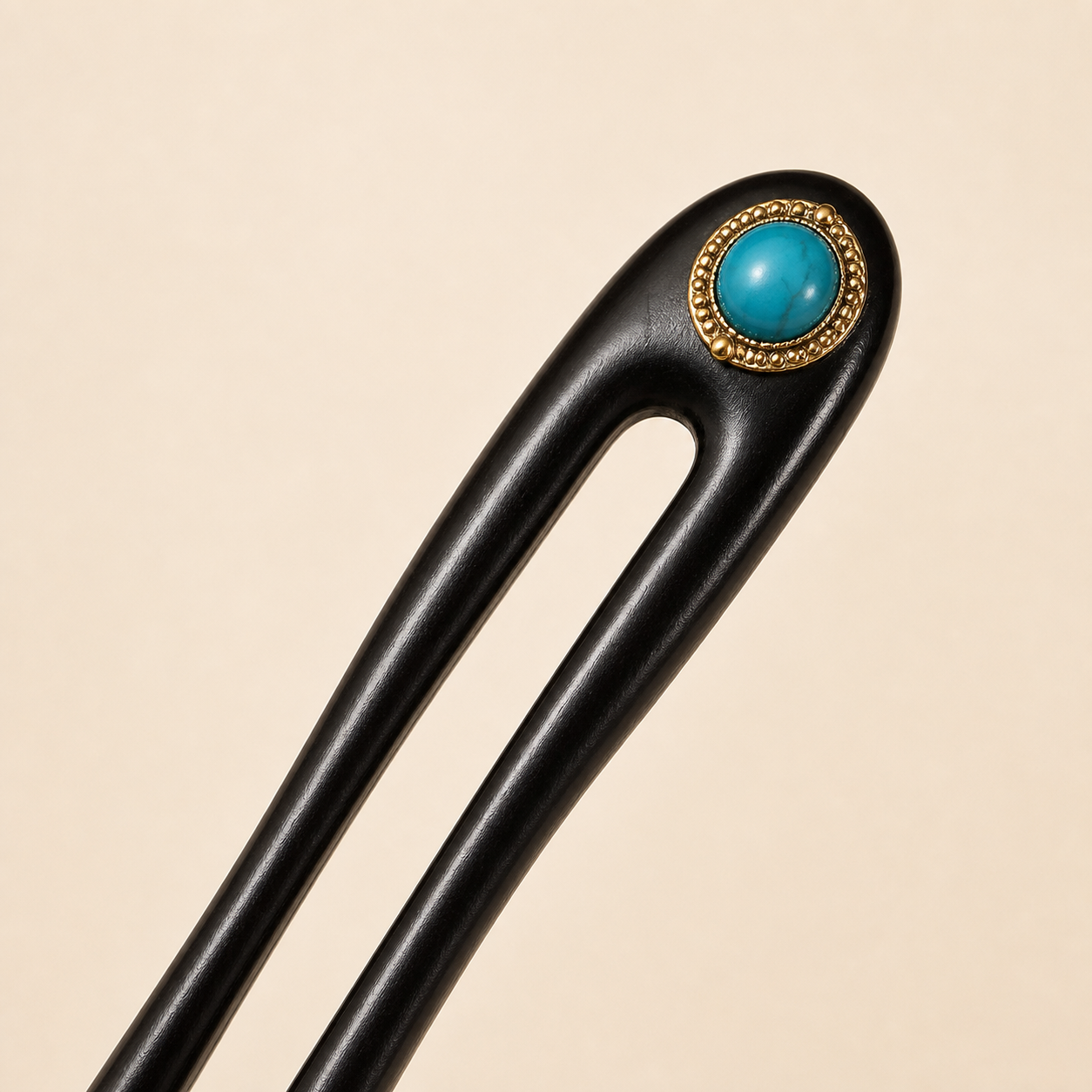 Close-up of turquoise ebony wooden hair fork with smooth hand-polished finish, natural wood grain, and elegant turquoise accent